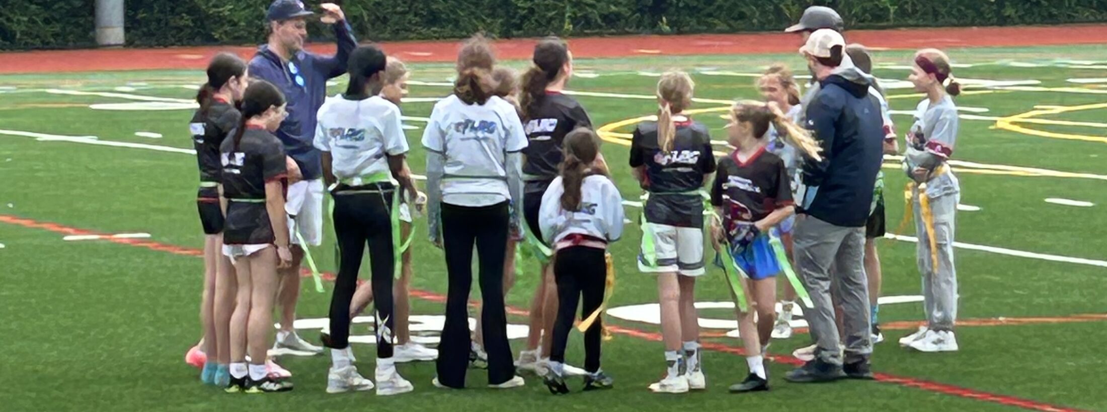 Pre-game huddle — Westport PAL girls flag football